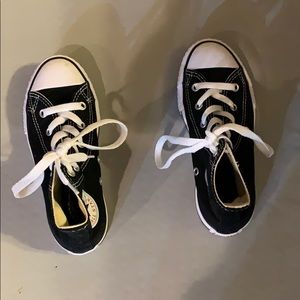 Black and white high top converse.